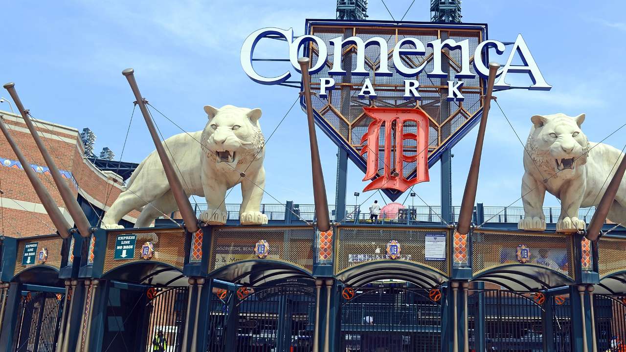 The entrance to a stadium with two tiger statues and a "Comerica Park" sign