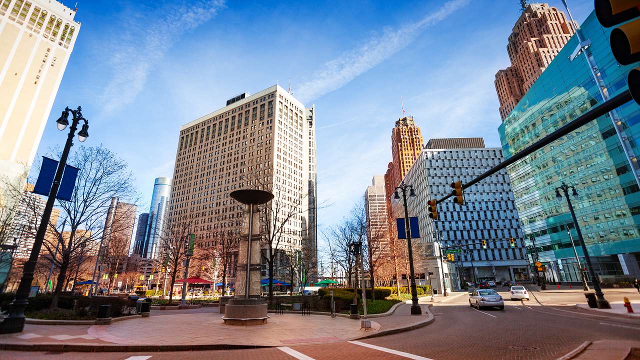 A paved square next to city buildings under a blue sky