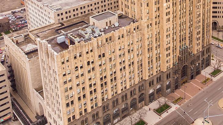 An aerial view of a tall Art Deco-style building with many windows