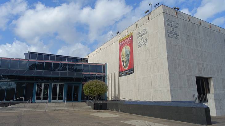 A large stone building with a "Houston Museum of Natural Science" sign