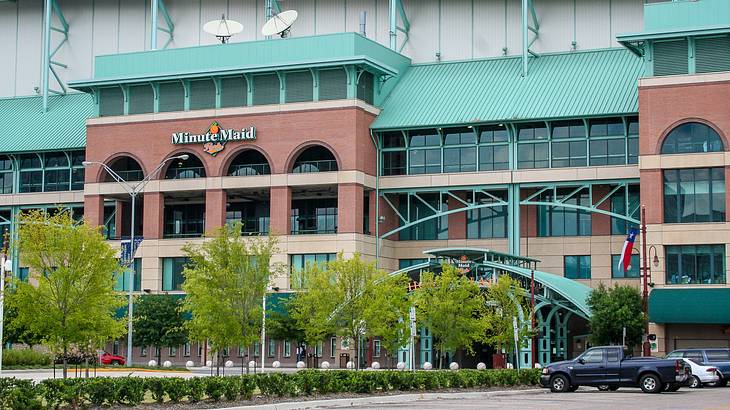 A brick and turquoise building with a "Minute Maid" sign