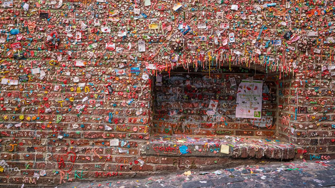 A brick wall covered in colored chewing gum