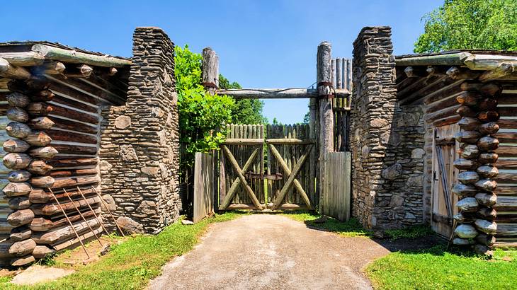 An entrance gate made of wood and rocks