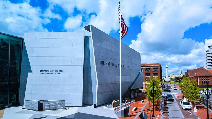 A building standing beside the American flag and a road on a cloudy day