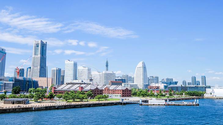 A city skyline near a body of water under a blue sky