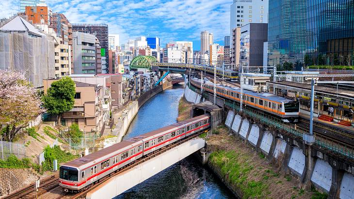 Train railways surrounded by buildings and body of water