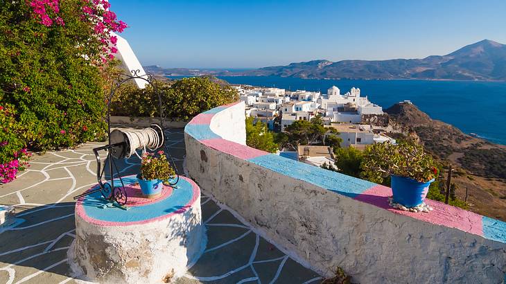 A view of a village near the sea and mountains from a colorful patio