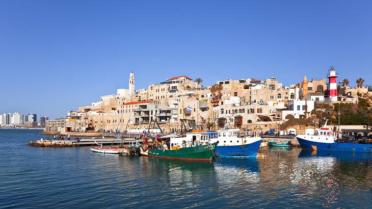 A view of a port with boats moored near old buildings