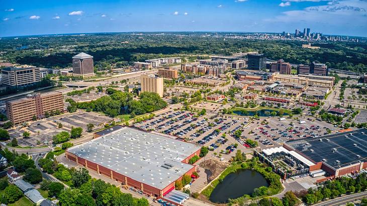 Aerial shot of a city with a large parking lot and buildings