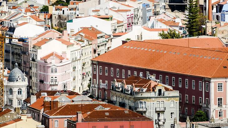 An aerial shot of a city with adjoining white and orange buildings