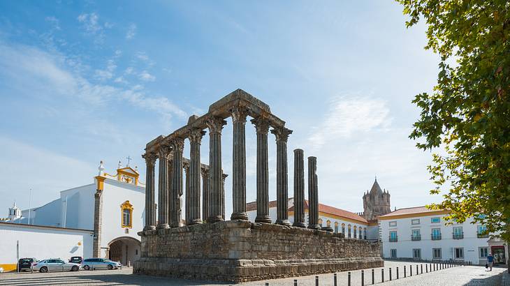 The ruins of columns surrounded by buildings
