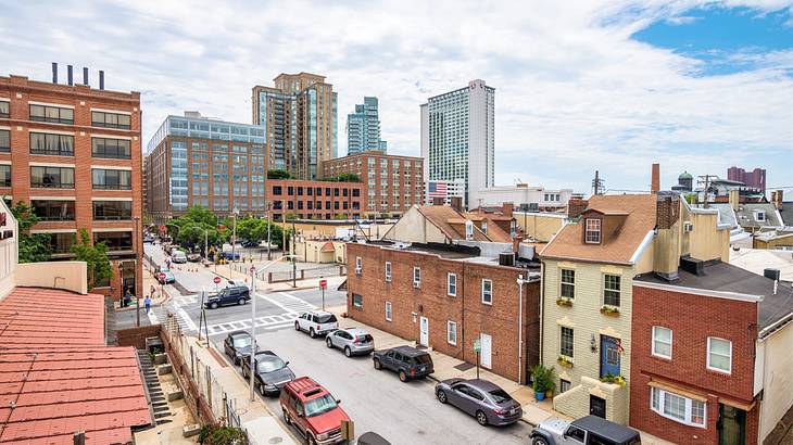 Aerial shot of a road with cars surrounded by buildings