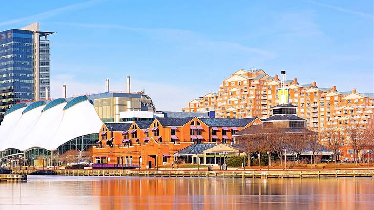 Modern structures near a body of water under a blue sky