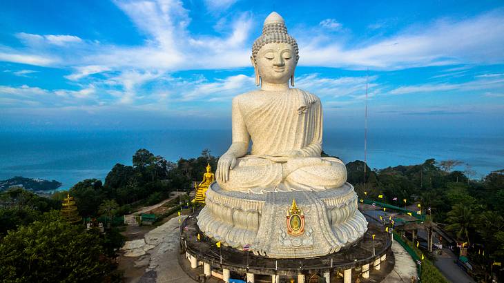 A massive statue of Buddha atop a mountain