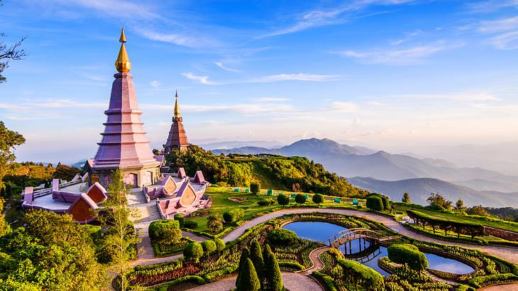 Two pagodas surrounded by landscaped gardens atop a mountain