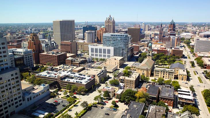 Aerial shot of city buildings and roads on a sunny day