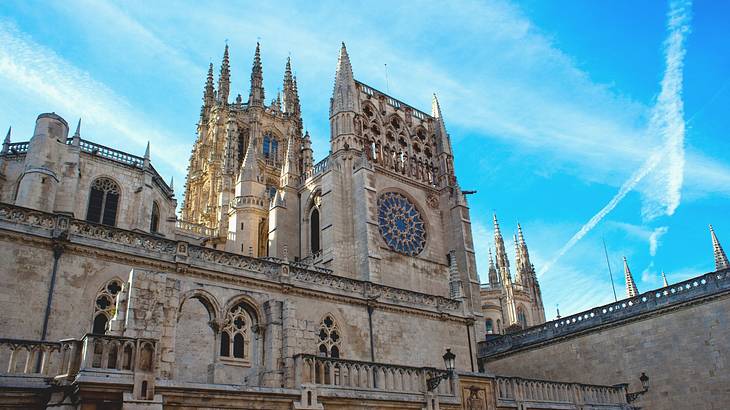 A Catholic church's facade against a blue sky from below