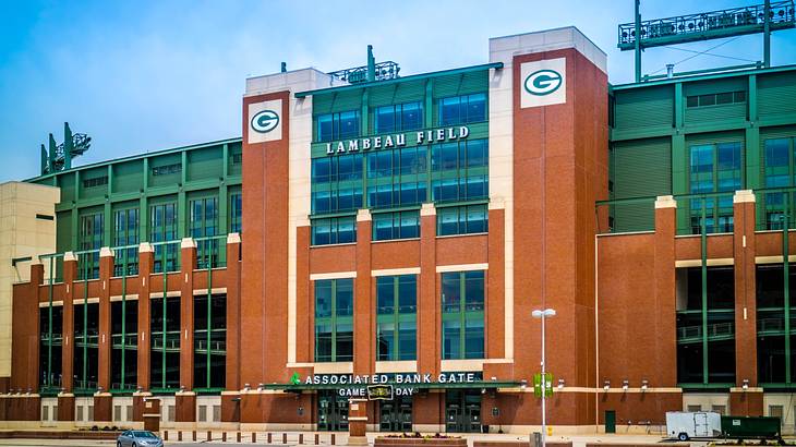 Facade of a red brick building with green accents and large "G" letters