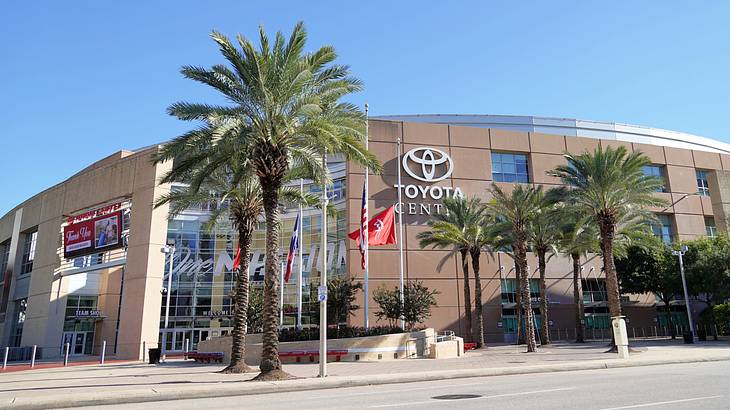A facade of a building with a sign saying "Toyota" near palm trees