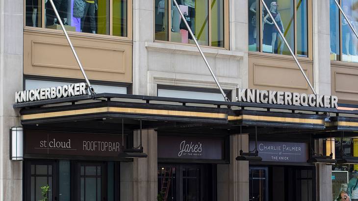 A hotel building with "Knickerbocker" signs and signage for restaurants and bars