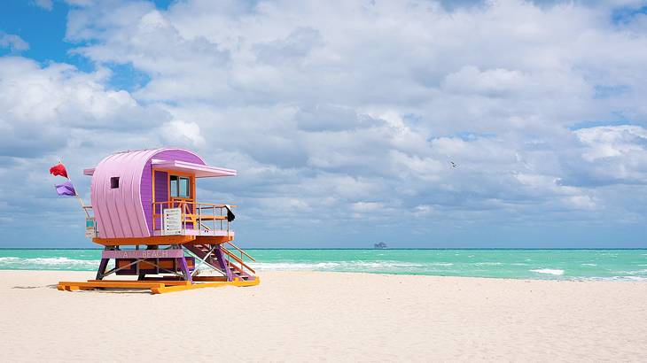 A colorful wooden lifeguard post by an empty beach