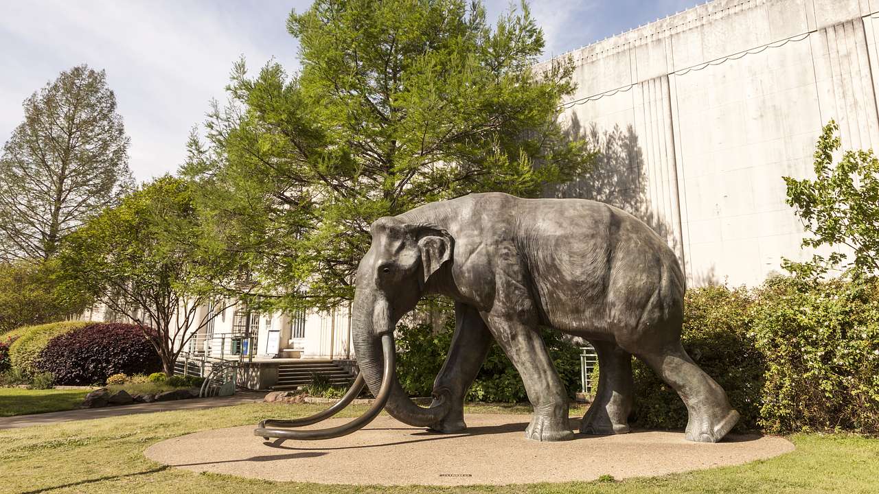 A statue of an elephant surrounded by trees