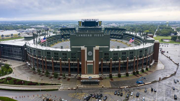 A top view of a large open-air sports stadium featuring a "Lambeau Field" sign