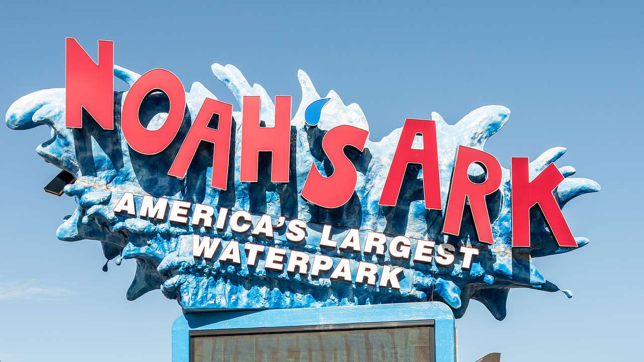A sign that reads "Noah's Ark: America's Largest Waterpark" atop a stone wall