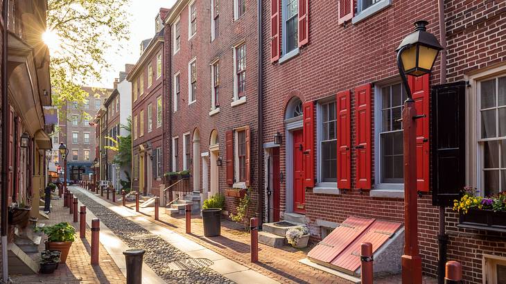 An alleyway surrounded by old brick houses on a sunny day
