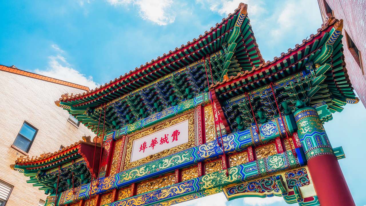 A colorful road archway with Chinese-style designs and characters