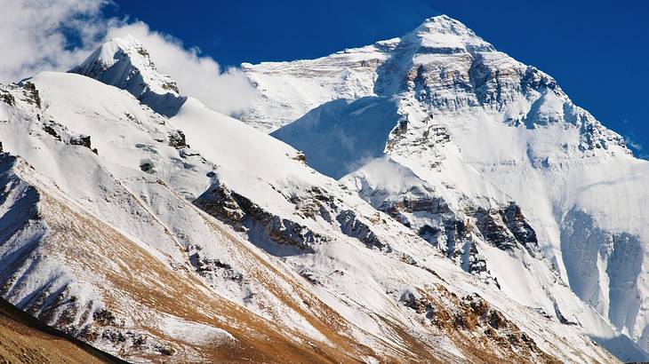 Up-close snow covered mountain tops with jagged terrain