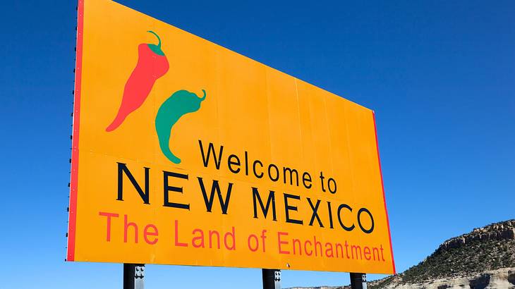 A road sign saying "Welcome to New Mexico, The Land of Enchantment"