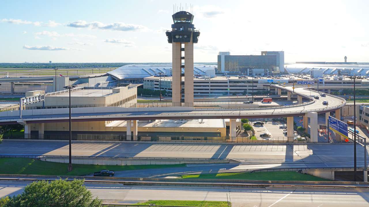 An airport with an observation tower near a bridge