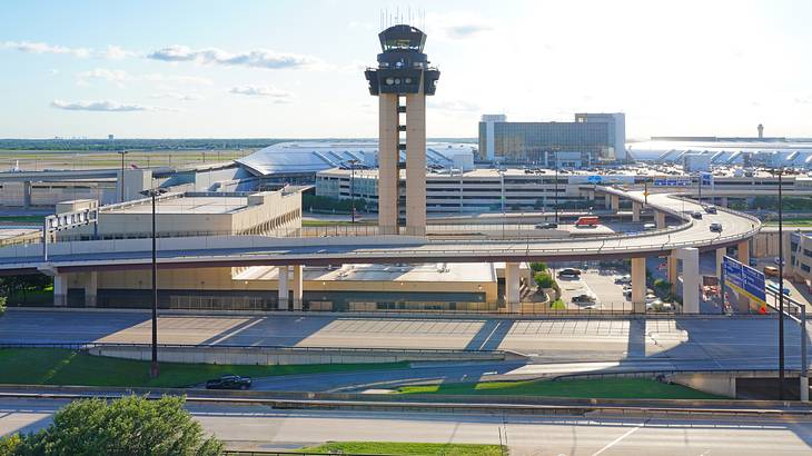 An airport with an observation tower near a bridge