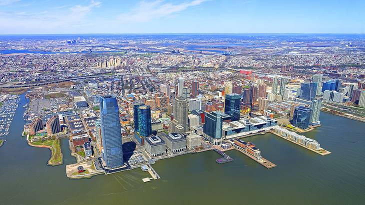 An aerial shot of an urban city surrounded by water