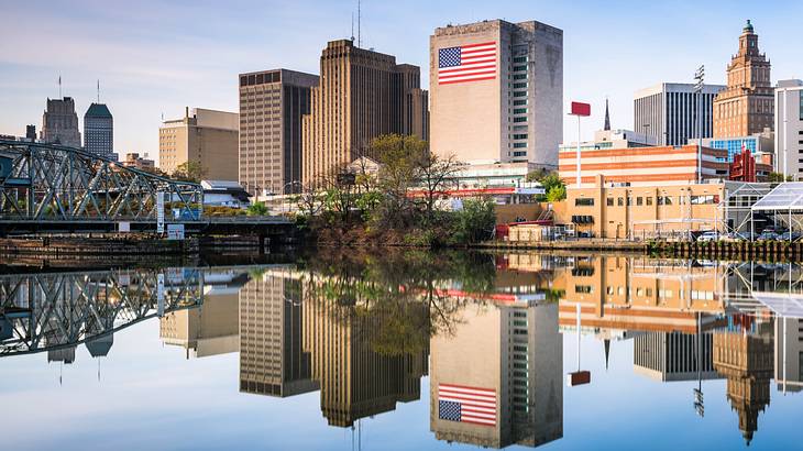 Buildings and a bridge with their reflection on the river