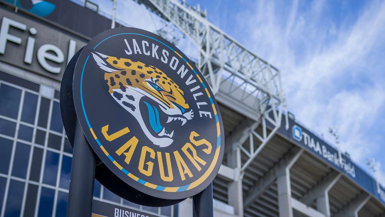 A logo in front of a building with a jaguar cartoon image and "Jacksonville Jaguars"