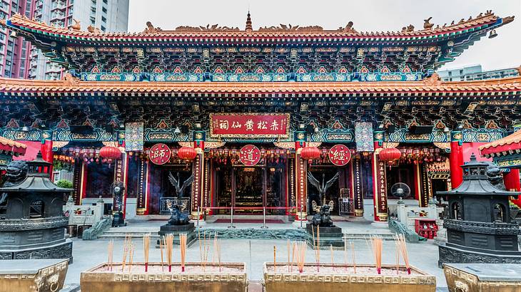 Incense in front of a colorful patterned temple