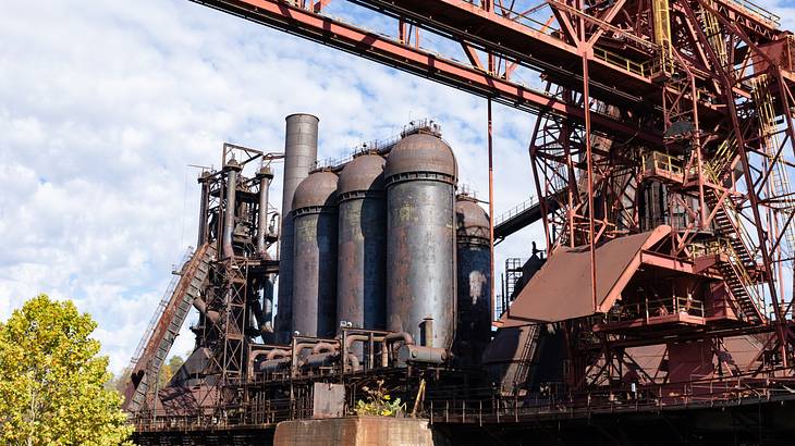 Rusty steel mills under a cloudy sky