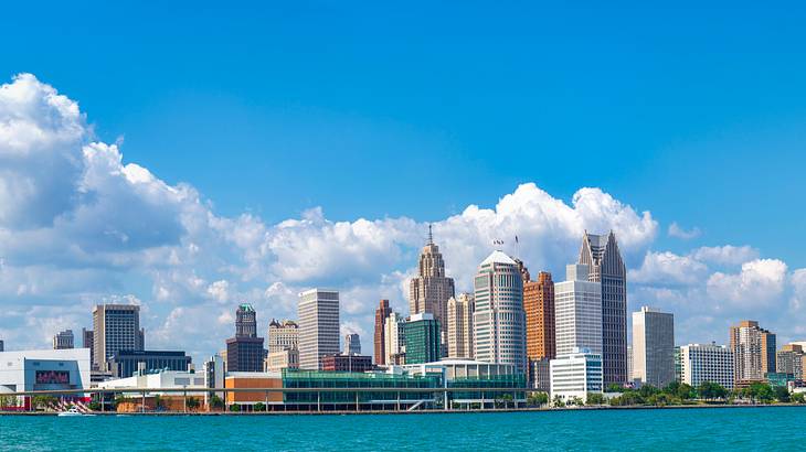 City skyline near a body of water on a cloudy day