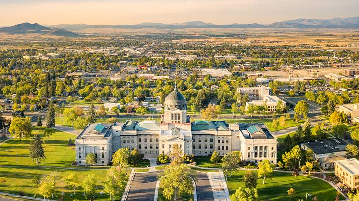 Aerial shot of a massive neo-classical building with a dome at its center