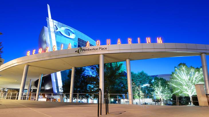 The exterior of an aquarium with a "Georgia Aquarium" sign on it