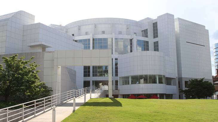 A modern white building with a path and patch of grass in front of it