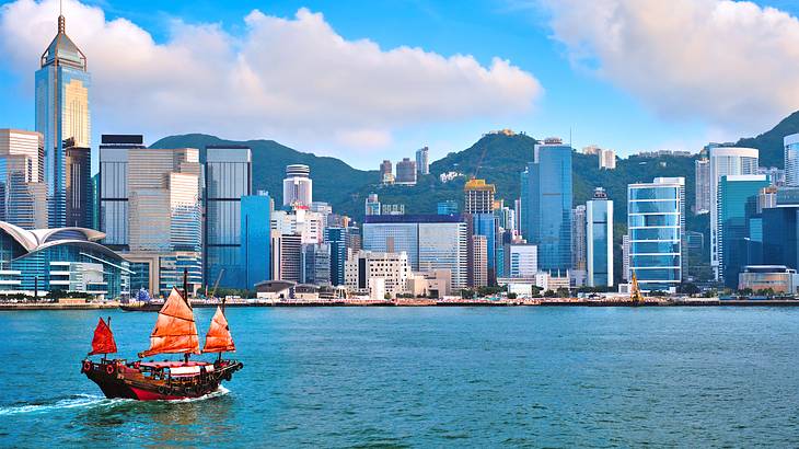 A harbor with a ship and buildings in the background in Hong Kong