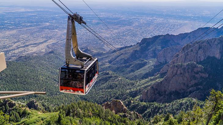 A cable car over a forested mountain range