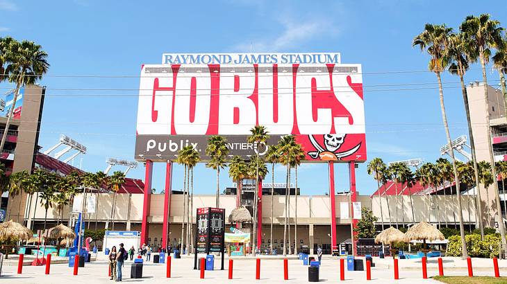 A billboard sign saying "Raymond James, Go Bucks" on the entrance to a stadium