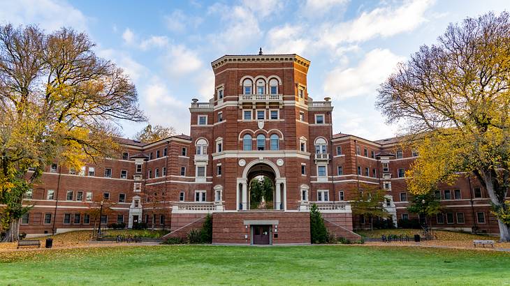 A bricked building with a lush lawn in front