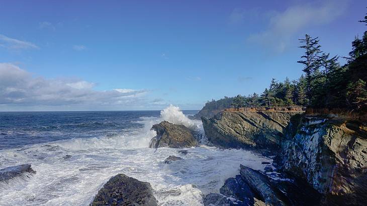 Ocean waves crashing into large rock formations