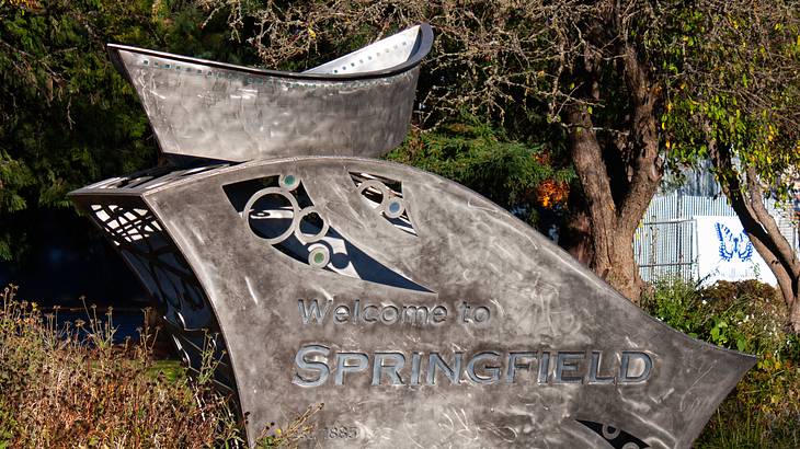 A large steel welcome road sign saying "Welcome to Springfield"