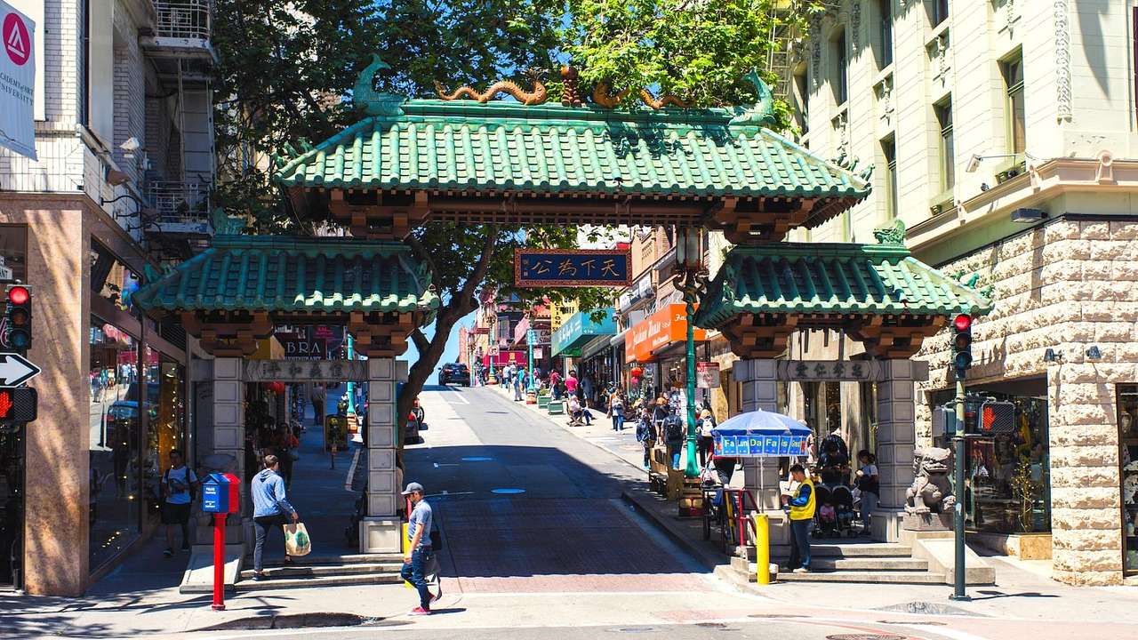 A Chinese-style entryway to a city's Chinatown with buildings next to it